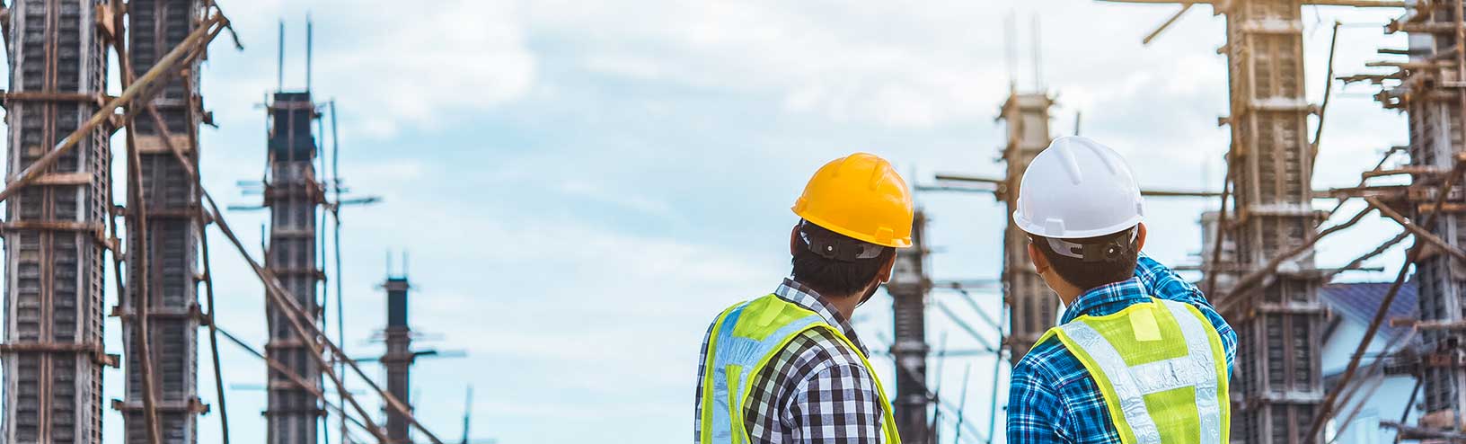 Two construction workers viewing and discussing work in progress