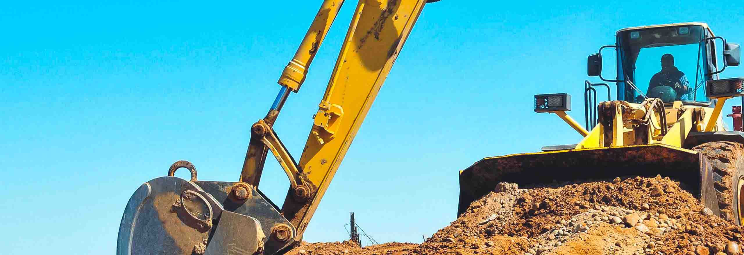 Baugeräte graben auf einer Baustelle